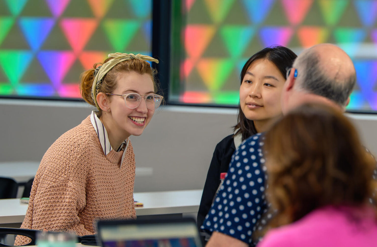 Attendees having a small group discussion during an event.